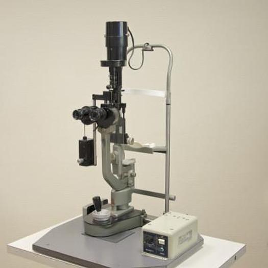 Used MAGNON SLIT LAMP WITH THREE-DIMENSIONAL MOVEMENTS AND LEVELLING TONOMETER, ON HEIGHT-ADJUSTABLE TABLE WITH CASTORS