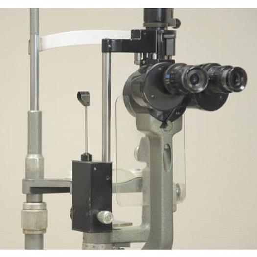 Used MAGNON SLIT LAMP WITH THREE-DIMENSIONAL MOVEMENTS AND LEVELLING TONOMETER, ON HEIGHT-ADJUSTABLE TABLE WITH CASTORS