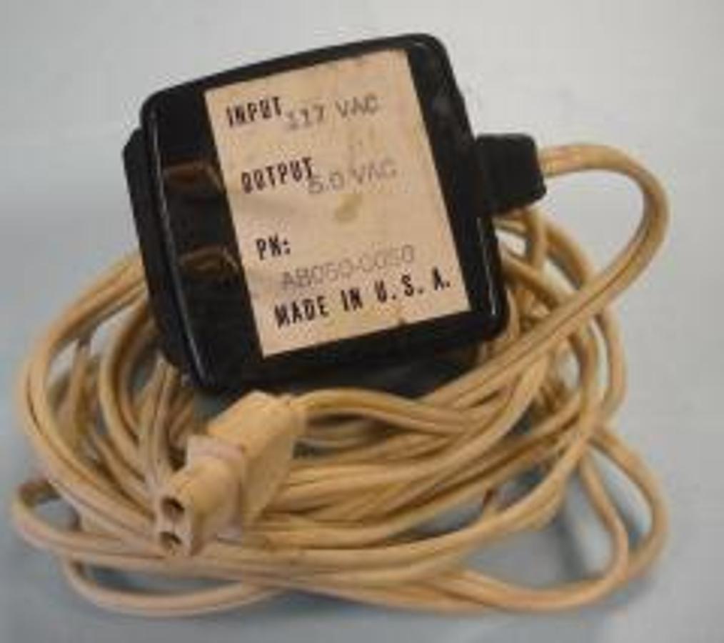 Used EQUIPMENT CABLE WITH TRANSFORMER WHITE 9 FOOT 11 INCHES P/N AB050-0050 INPUT 117VAC OUTPUT 5 VAC 2 WAY PLUG ON OTHER SIDE TWO HOLE CONNECTOR.