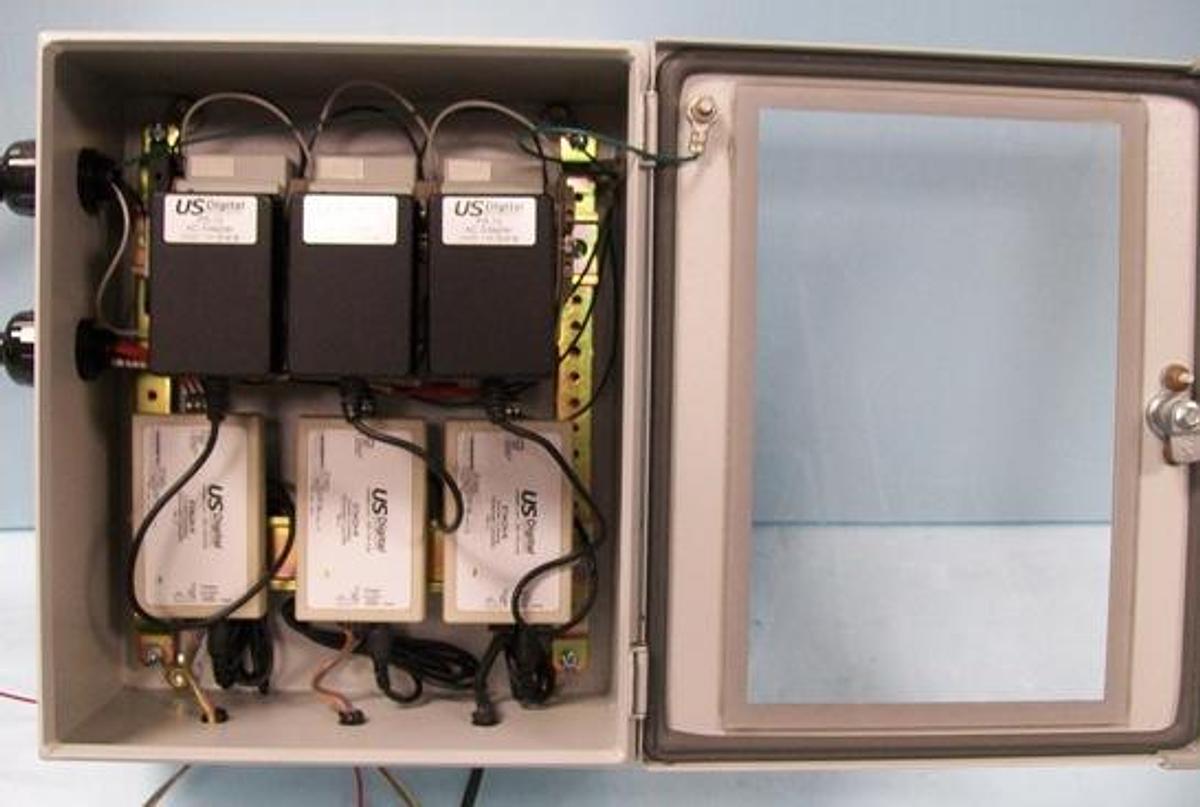 Used POWER/CONTROL BOX WITH (3) US DIGITAL PS-12 AC ADAPTOR P/N: 9NA0180101 SERIAL # (1) H00002506