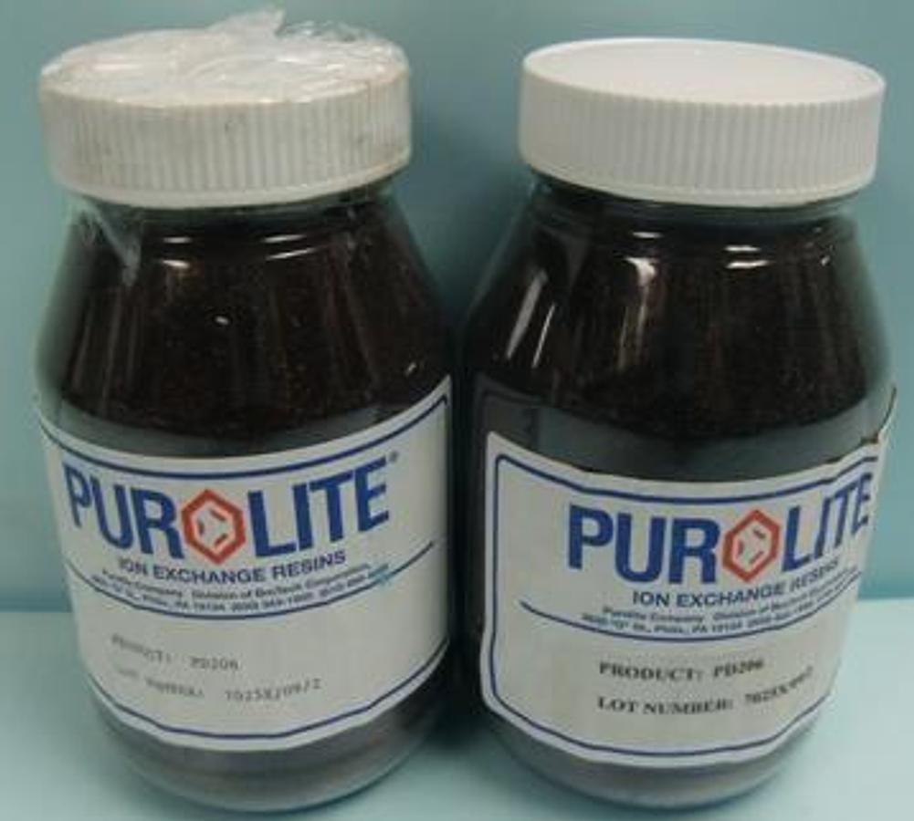 Used PUROLITE ION EXCHANGE RESINS PD206 LOT NO.:7025X/09/2. IN CLEAR GLASS JAR .
